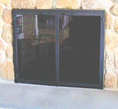 New Seabury fireplace doors on stone, black finish vice bi fold doors, standard smoked glass   (on stone firebox)
